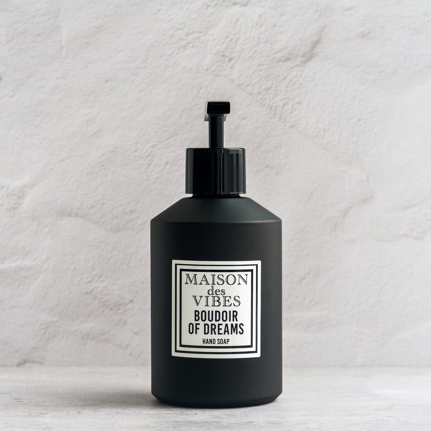 Maison des Vibes' BOUDOIR OF DREAMS liquid hand soap in the classic black bottle with a white and black square logo on a white background. 