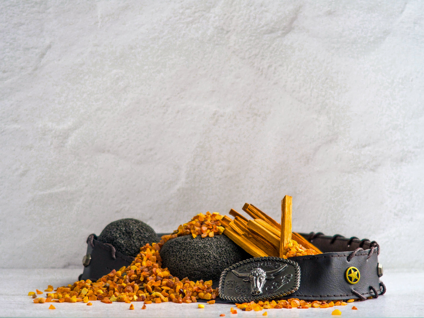 Maison des Vibes CAMP Room Spray. Photo depiction of fragrance notes in CAMP. Top: Sandalwood Heart: Leather Base: Smoked Amber. 