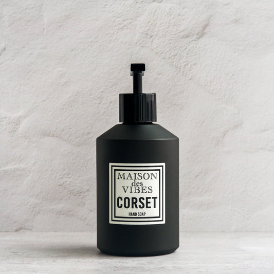Maison des Vibes' Corset liquid hand soap in the classic black bottle with a white and black square logo on a white background. 